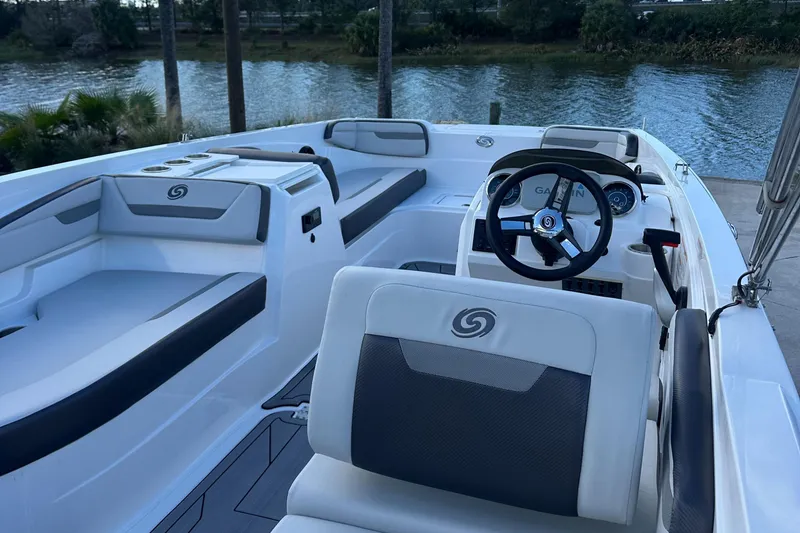 Slide: The Image of 2023 Hurricane SunDeck Sport 205 OB boat interior with seating and steering wheel. - 4