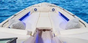 Slide: The Image of 2025 Grady-White Freedom 345 boat interior with cushioned seating and ocean backdrop. - 10