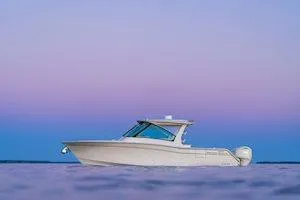Slide: The Image of 2025 Grady-White Freedom 345 boat on calm water at sunset. - 4