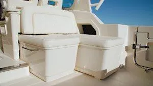 Slide: The Image of 2025 Grady-White Freedom 345 boat interior with white seating and storage compartments. - 6
