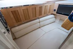 Slide: The Image of Interior of 2025 Grady-White Freedom 345 boat with modern seating and wood paneling. - 8