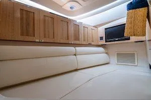 Slide: The Image of Luxurious interior of 2025 Grady-White Freedom 345 boat with plush seating and wooden cabinets. - 9
