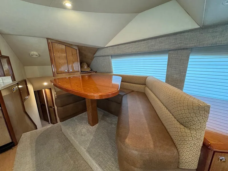 Slide: The Image of Interior of 2008 Ocean Yachts 54 Super Sport with cozy dining area and wooden table. - 18