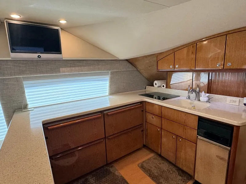 Slide: The Image of Luxurious kitchen interior of 2008 Ocean Yachts 54 Super Sport with wood cabinetry and modern appliances. - 19