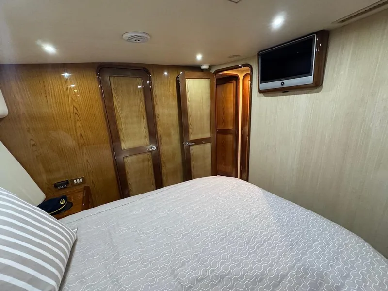 Slide: The Image of Luxurious cabin interior of 2008 Ocean Yachts 54 Super Sport with wood paneling and TV. - 26