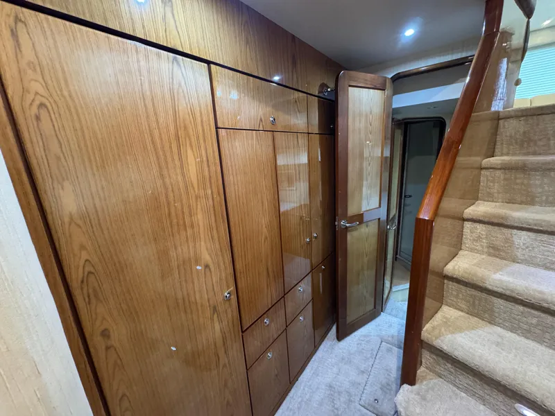 Slide: The Image of Interior of 2008 Ocean Yachts 54 Super Sport, featuring wooden cabinetry and carpeted stairs. - 30