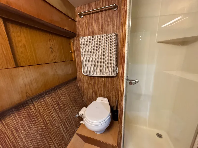 Slide: The Image of 2008 Ocean Yachts 54 Super Sport bathroom with wood paneling and shower. - 33