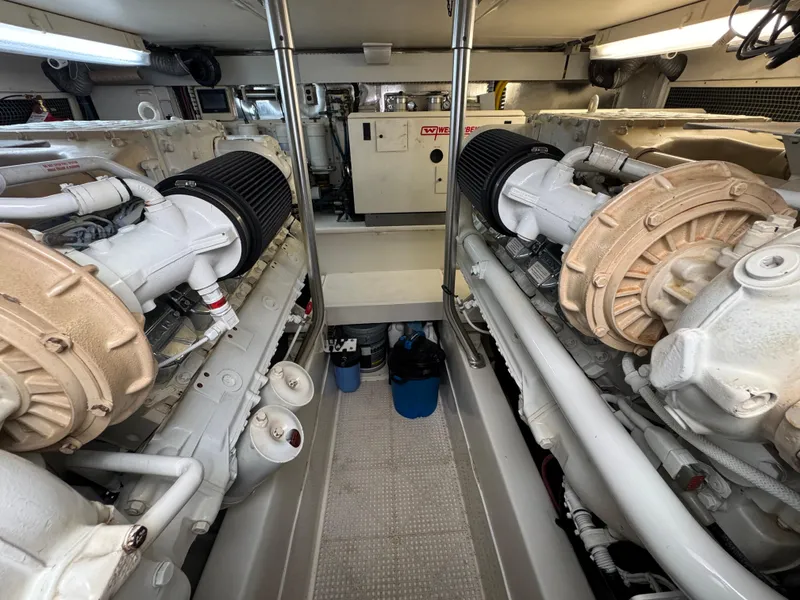 Slide: The Image of Engine room of a 2008 Ocean Yachts 54 Super Sport, featuring dual engines and mechanical components. - 42