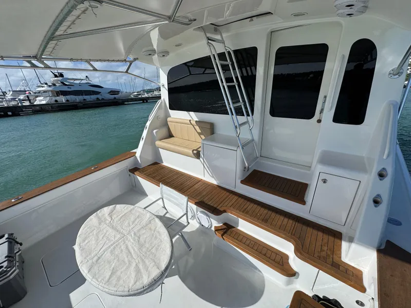 Slide: The Image of 2008 Ocean Yachts 54 Super Sport yacht deck with seating, table, and ladder, docked at marina. - 49
