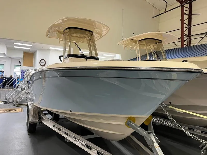 Slide: The Image of 2025 Grady-White Fisherman 216 boat displayed indoors on a trailer. - 0