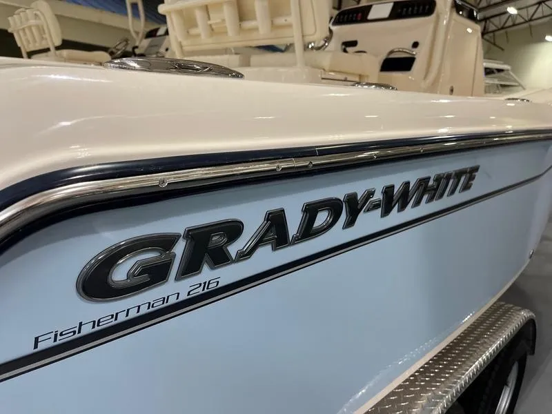 Slide: The Image of 2025 Grady-White Fisherman 216 boat, close-up of logo and side view. - 1