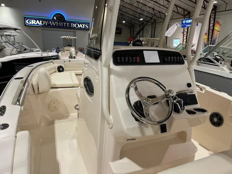 Slide: The Image of 2025 Grady-White Fisherman 216 boat interior with steering console in showroom. - 11