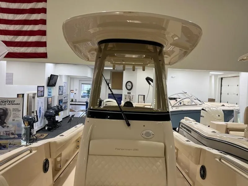 Slide: The Image of 2025 Grady-White Fisherman 216 boat in showroom, featuring sleek design and modern amenities. - 14