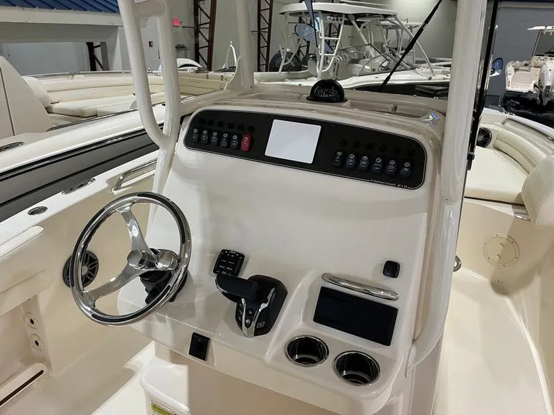 Slide: The Image of 2025 Grady-White Fisherman 216 boat dashboard with steering wheel and controls. - 2