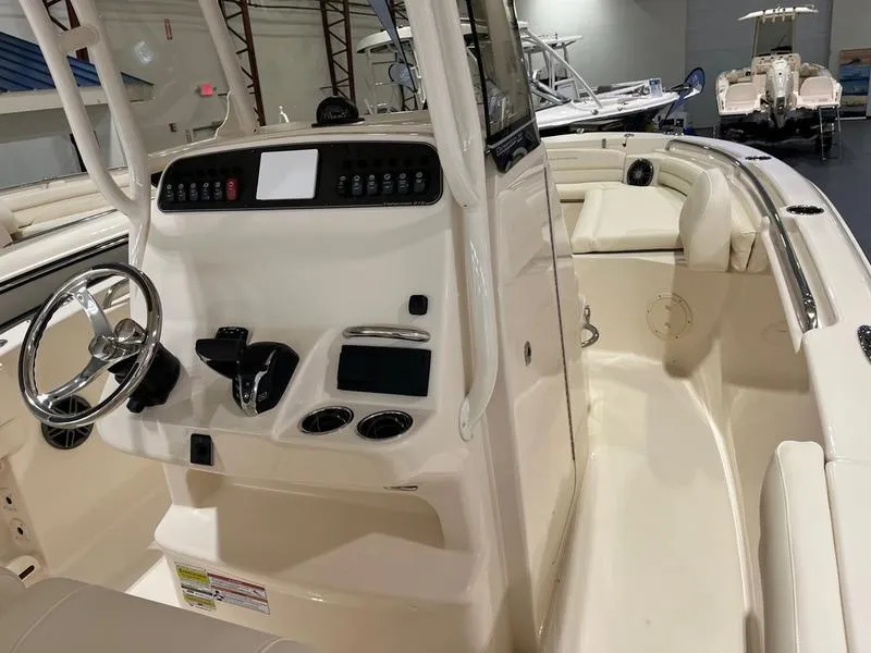 Slide: The Image of 2025 Grady-White Fisherman 216 boat interior with steering console and seating area. - 6