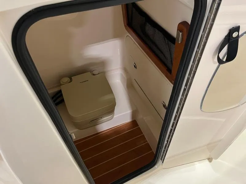 Slide: The Image of 2025 Grady-White Fisherman 216 boat interior with compact marine toilet. - 8