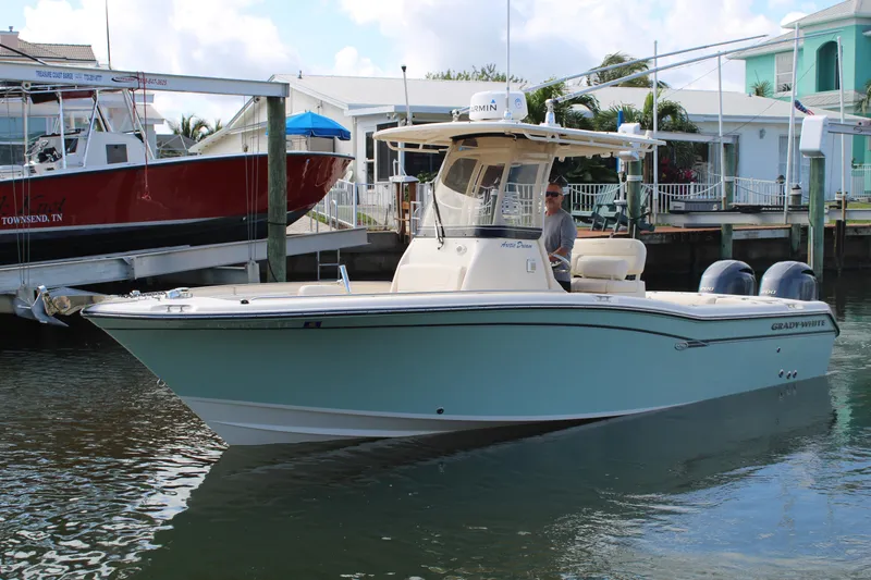 The Image of 2018 Grady-White Fisherman 257 boat docked in marina, calm water, clear sky. - 0