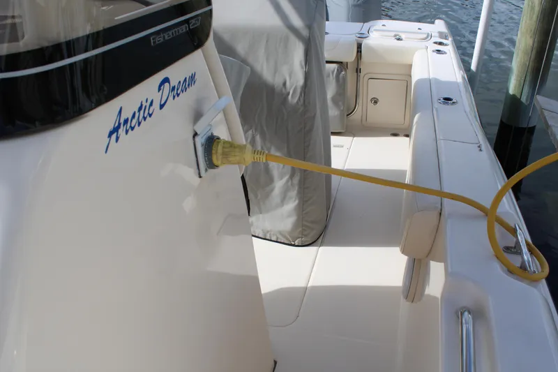 Slide: The Image of 2018 Grady-White Fisherman 257 boat with "Arctic Dream" name, docked with power cable connected. - 16