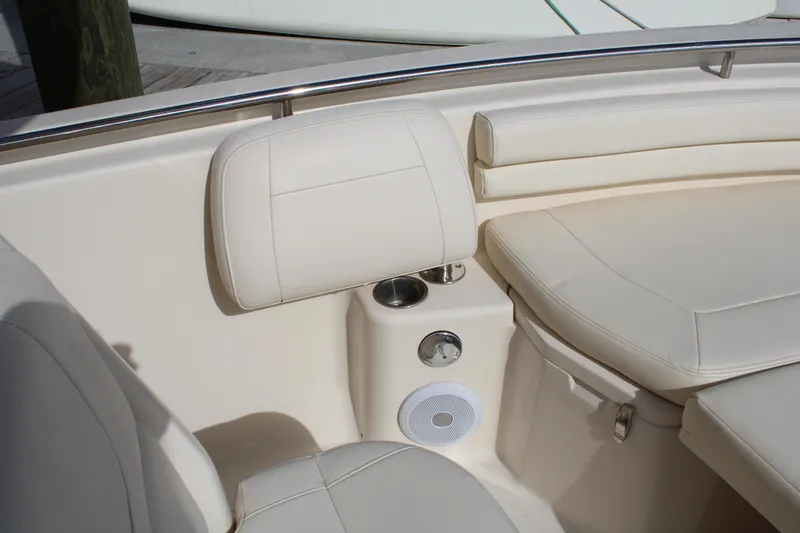 Slide: The Image of 2018 Grady-White Fisherman 257 boat interior with beige seating and cup holders. - 18