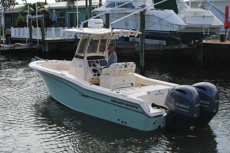 Slide: The Image of 2018 Grady-White Fisherman 257 boat with dual Yamaha engines docked in marina. - 2