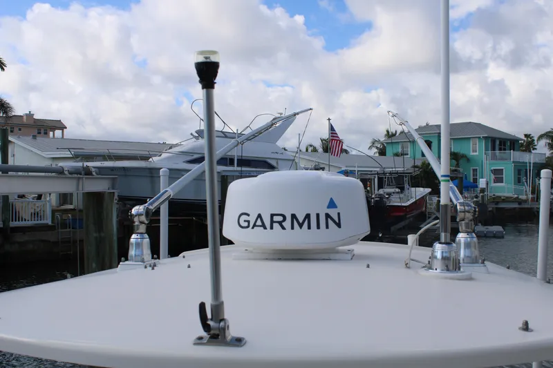 Slide: The Image of 2018 Grady-White Fisherman 257 with Garmin equipment, docked near waterfront homes. - 21
