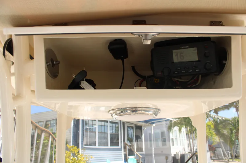 Slide: The Image of 2018 Grady-White Fisherman 257 boat console with radio and storage compartment. - 33