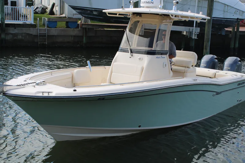 Slide: The Image of 2018 Grady-White Fisherman 257 boat on water, featuring sleek design and twin engines. - 4