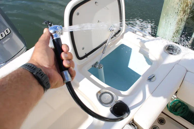 Slide: The Image of 2018 Grady-White Fisherman 257 boat with livewell and hose in use. - 40