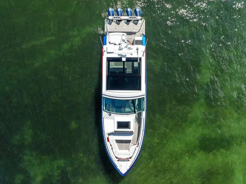 Slide: The Image of 2023 Formula 430 Super Sport Crossover boat on clear green water, aerial view. - 10