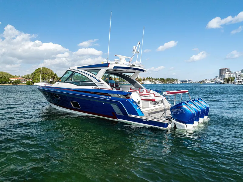 Slide: The Image of 2023 Formula 430 Super Sport Crossover boat on water, blue sky background. - 11