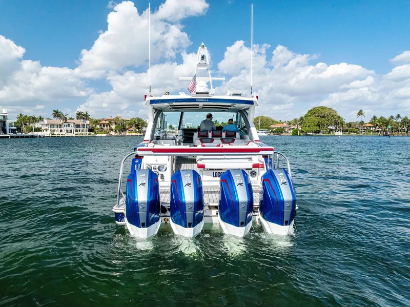Slide: The Image of 2023 Formula 430 Super Sport Crossover boat with four engines on a sunny day. - 13