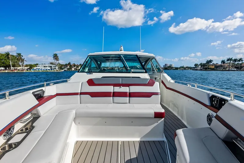 Slide: The Image of 2023 Formula 430 Super Sport Crossover boat on water, featuring spacious seating and sleek design. - 15