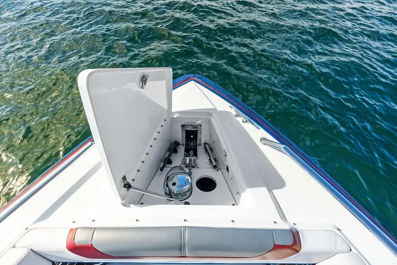 Slide: The Image of 2023 Formula 430 Super Sport Crossover boat anchor compartment on calm water. - 21