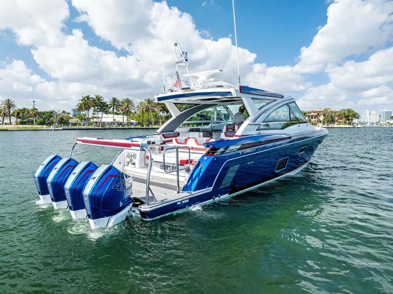 Slide: The Image of 2023 Formula 430 Super Sport Crossover boat on water, featuring four powerful outboard engines. - 3