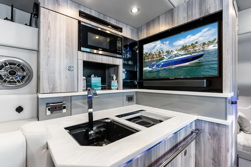 Slide: The Image of 2023 Formula 430 Super Sport Crossover interior with modern kitchen and entertainment system. - 42