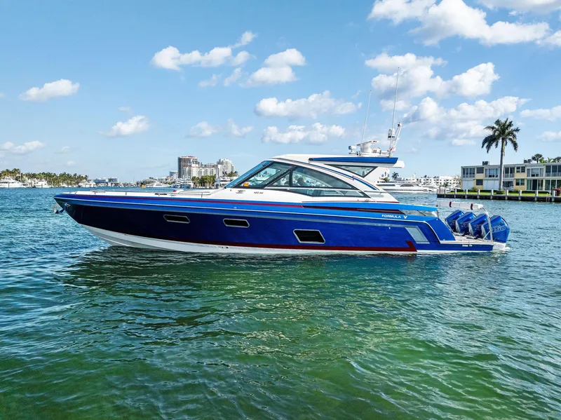 Slide: The Image of 2023 Formula 430 Super Sport Crossover boat on clear blue water. - 5