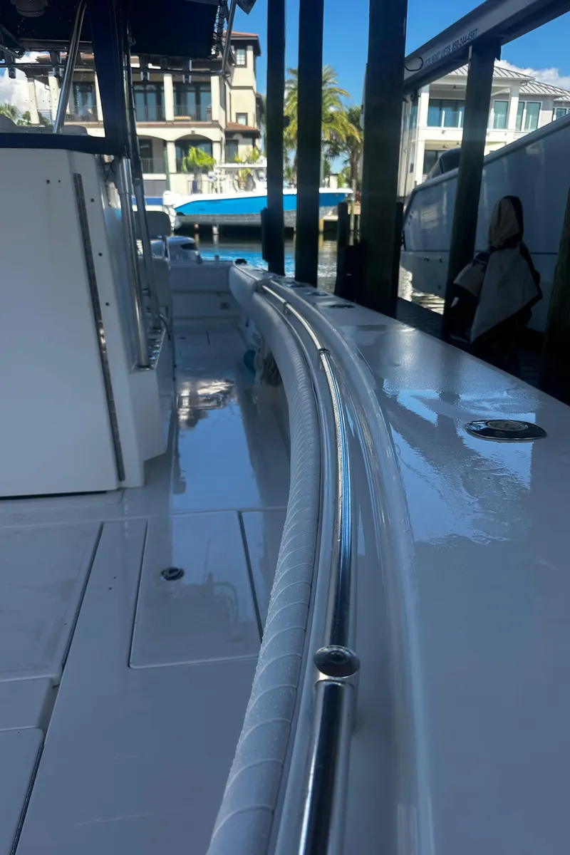 Slide: The Image of 2008 Contender 32 Tournament boat docked, showcasing sleek design and polished railings. - 14