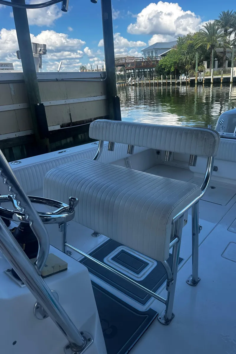 Slide: The Image of 2008 Contender 32 Tournament boat interior with seating, docked by a scenic waterfront. - 18