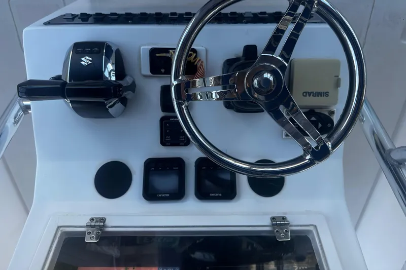 Slide: The Image of Dashboard of 2008 Contender 32 Tournament boat with steering wheel and controls. - 19