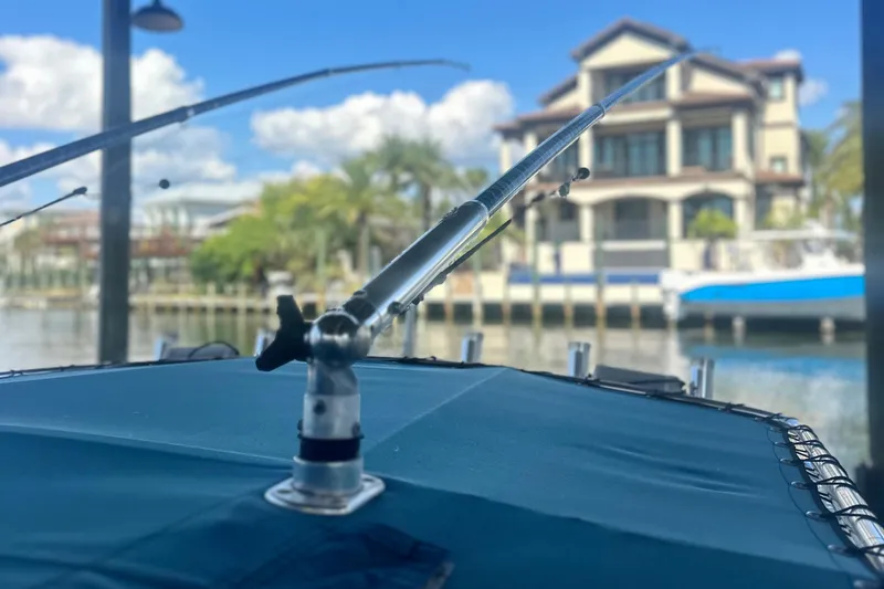 Slide: The Image of Fishing rod on a 2008 Contender 32 Tournament boat, with waterfront view. - 26