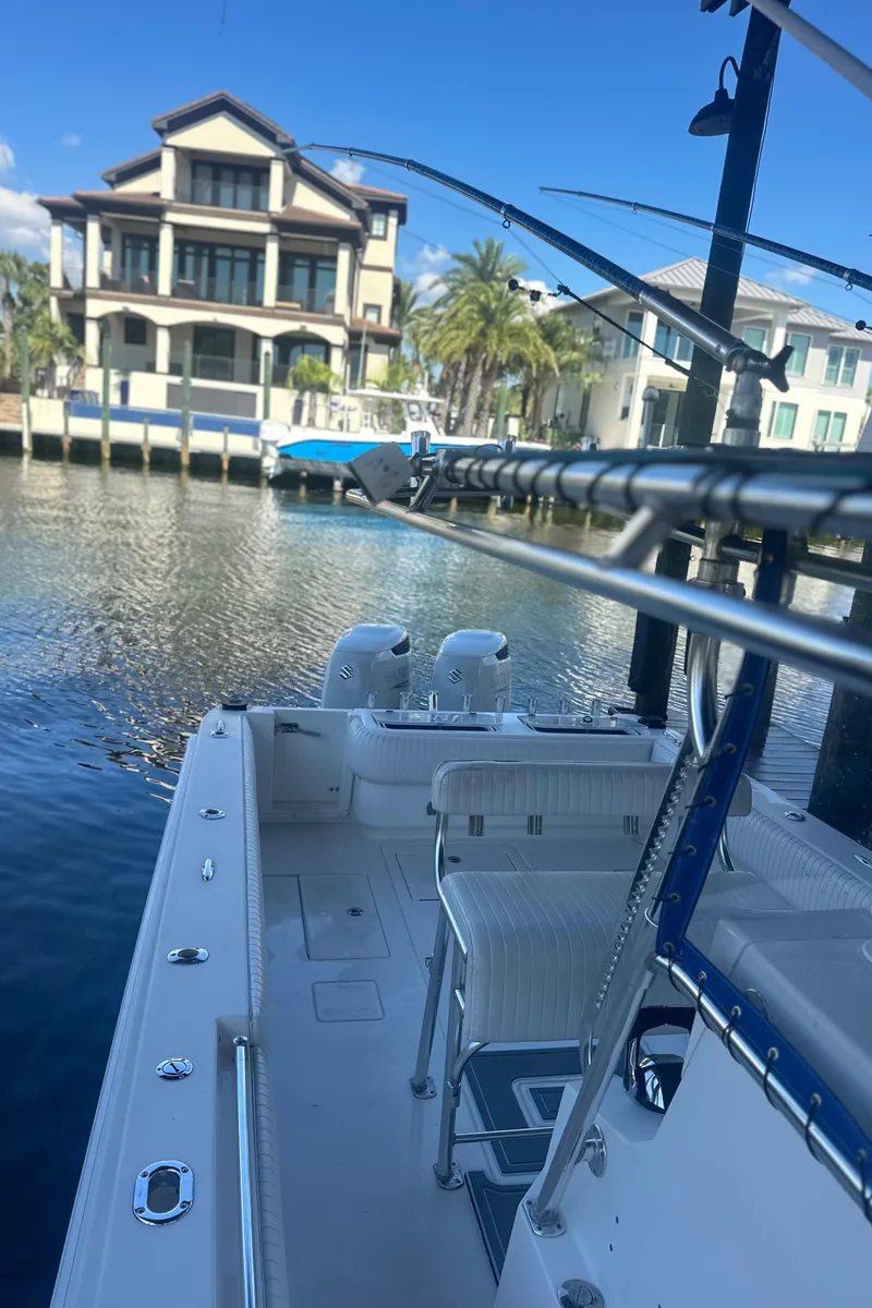 Slide: The Image of 2008 Contender 32 Tournament boat docked near waterfront homes. - 27