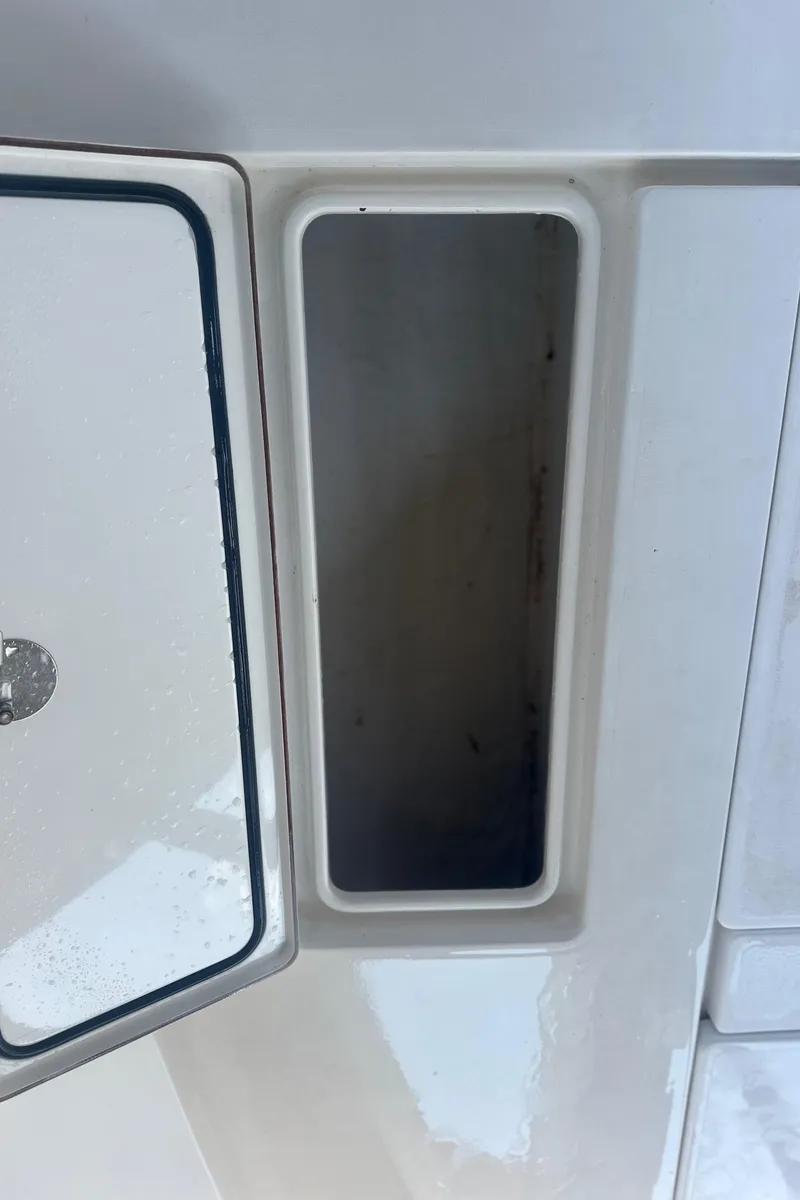 Slide: The Image of Open storage compartment on a 2008 Contender 32 Tournament boat. - 35