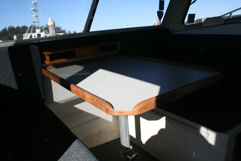 Slide: The Image of Interior of 1992 Sea Sport Sea Master 2700 with wooden-trimmed table and seating area. - 10