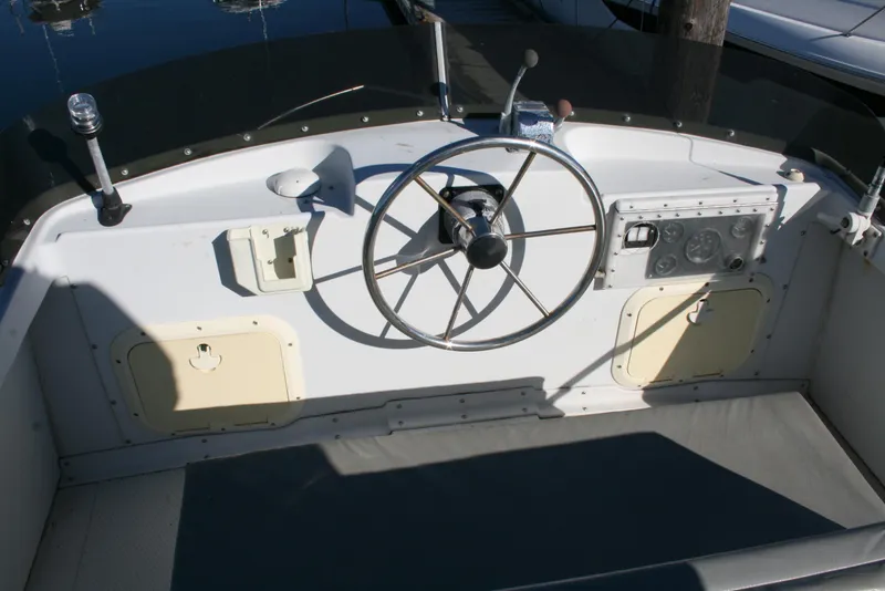 Slide: The Image of 1992 Sea Sport Sea Master 2700 helm with steering wheel and control panel. - 13