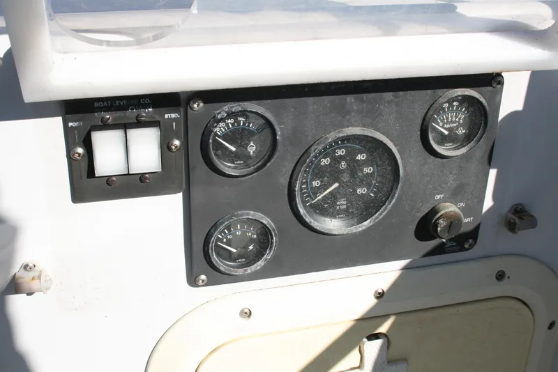 Slide: The Image of Control panel of a 1992 Sea Sport Sea Master 2700 boat with gauges and switches. - 14