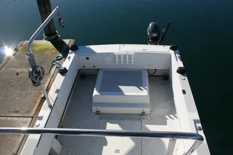 Slide: The Image of 1992 Sea Sport Sea Master 2700 boat deck with motor, docked at marina. - 17