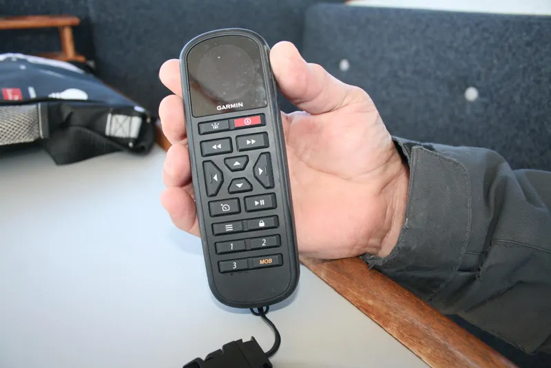 Slide: The Image of Hand holding a Garmin remote control on a Sea Sport Sea Master 2700 boat. - 18