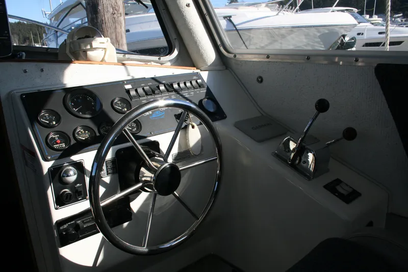 Slide: The Image of Interior view of 1992 Sea Sport Sea Master 2700 boat cockpit with steering wheel and controls. - 4