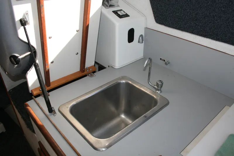 Slide: The Image of 1992 Sea Sport Sea Master 2700 kitchen sink area with faucet and countertop. - 9