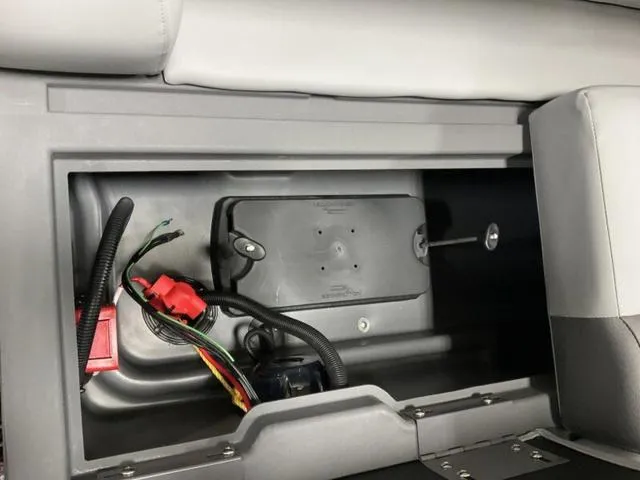 Slide: The Image of Storage compartment in a 2025 Bennington S L-Bench 21 SLJ boat, showing wiring and components. - 10